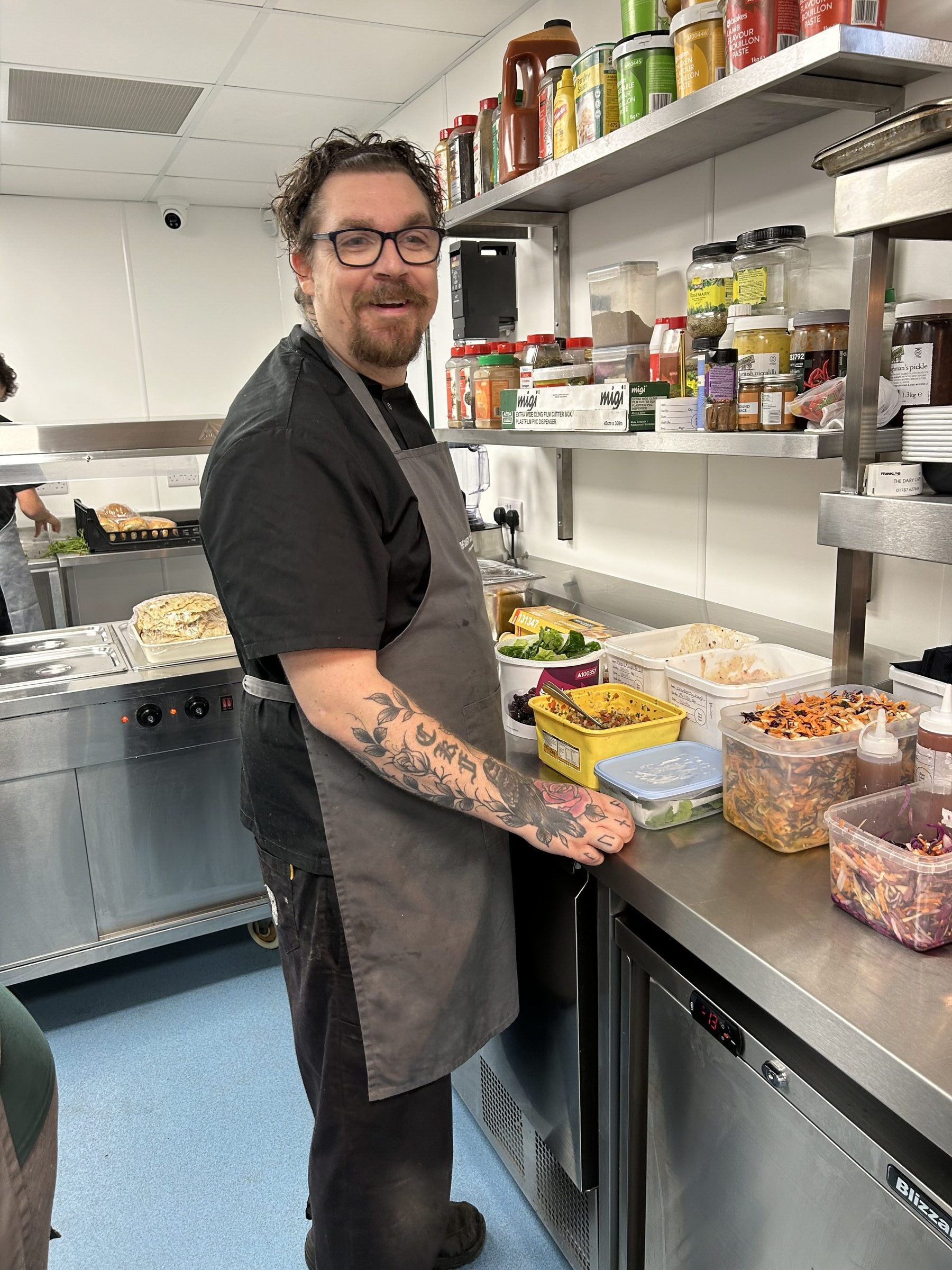A chef preparing food in the Dairy Café kitchen at Franklins Farm